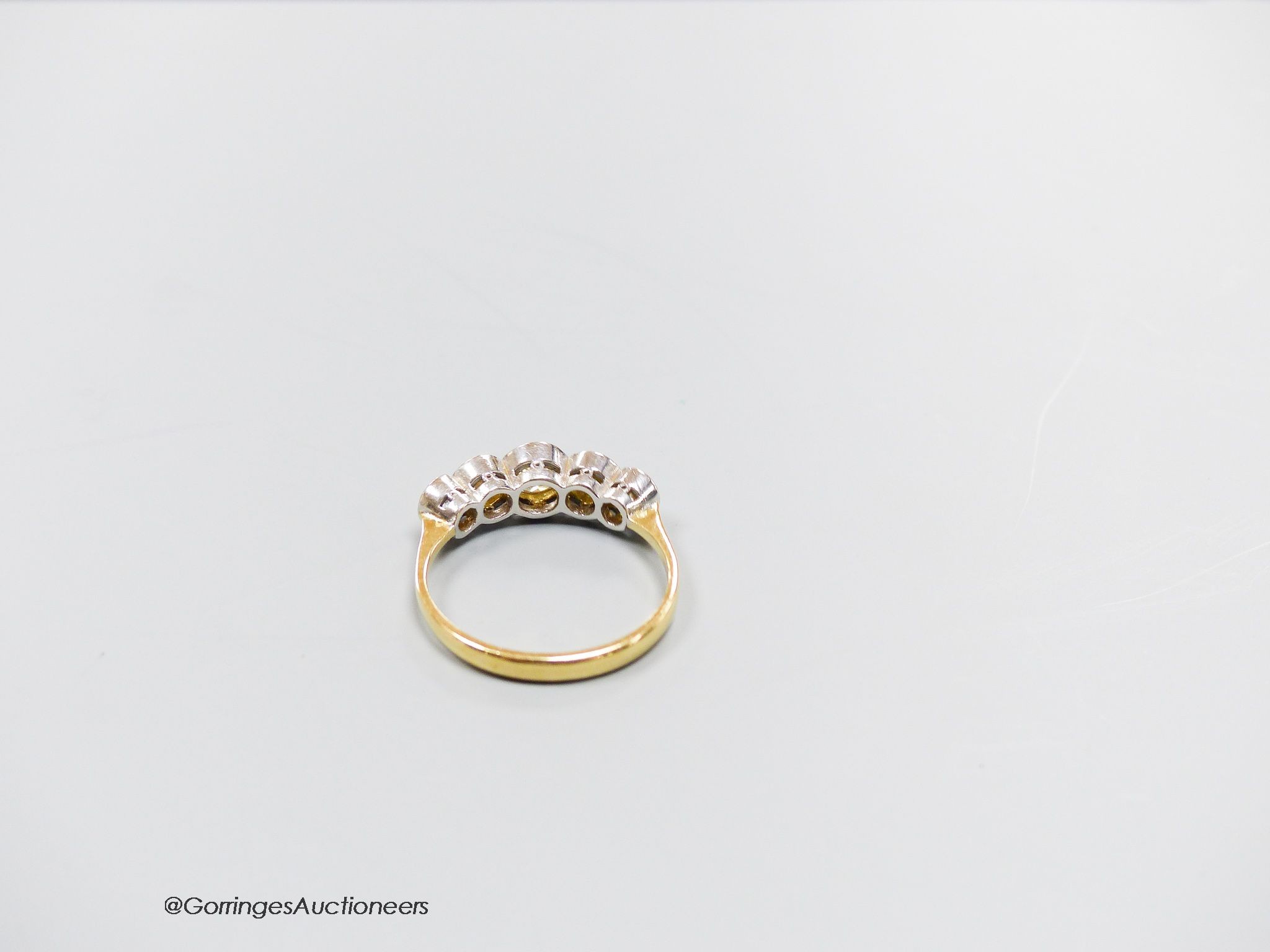 An 18ct gold five stone diamond ring, size T, gross 4.3g.